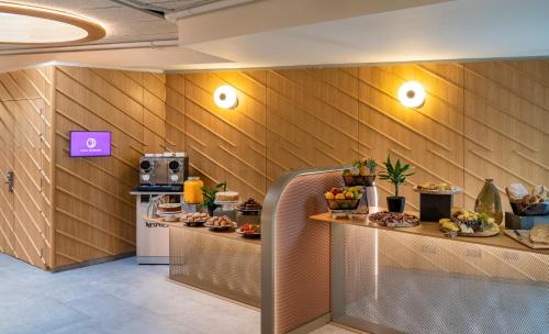 a lobby with a counter with food on it at Ibis Styles Madrid City Las Ventas in Madrid