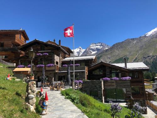 a canadian flag flying in front of a building at Boutique Lodge Spycher in Saas-Fee