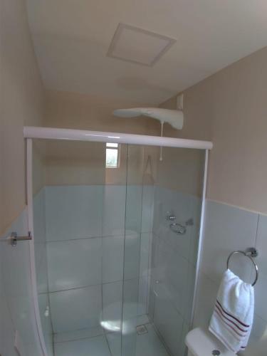 a bathroom with a shower with a glass door at Pousada Maresia in Fernando de Noronha