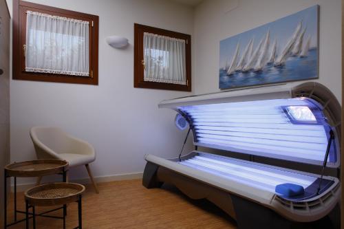 a hospital room with a bed and a chair at Agriturismo Villa Almè in Oderzo