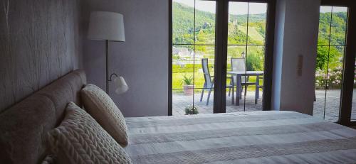a bedroom with a bed and a view of a patio at Ferienwohnung Probst in Ellenz-Poltersdorf