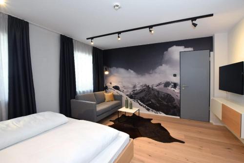 a bedroom with a bed and a couch and a tv at Mariandl im Oberwirt in Eggenfelden