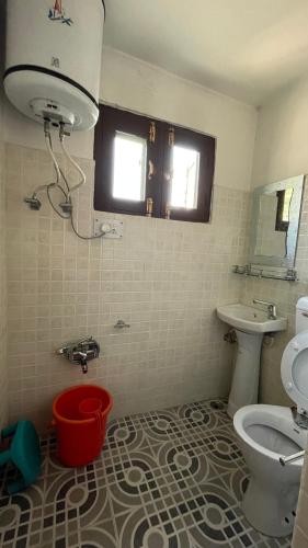 a bathroom with a toilet and a sink at Dilaram Guest House in Srinagar
