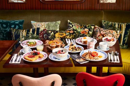 a table with plates of food on it at Mama Shelter Roma in Rome