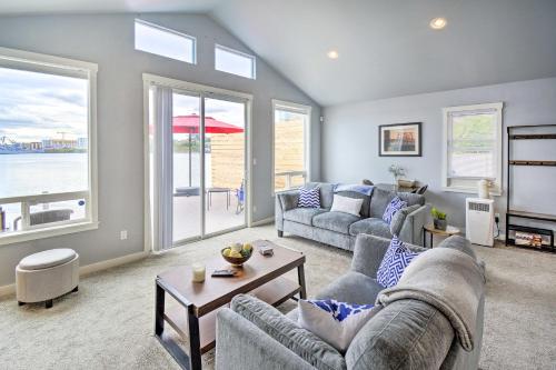 a living room with two couches and a table at Manette Waterfront Kayak the Bay and Walk to Town! in Bremerton