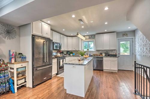 a kitchen with white cabinets and stainless steel appliances at Outdoor Pool and Hot Tub Retreat - 6 Mi to Dtwn! in Baltimore