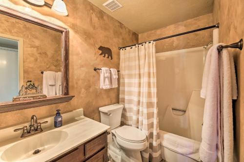 a bathroom with a toilet and a sink and a shower at Patio and Fireplace Country Club Pinetop Condo! in Indian Pine