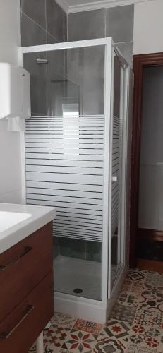 a shower with a glass door in a bathroom at ALOJAMIENTO CASA LEÓN in Santoña