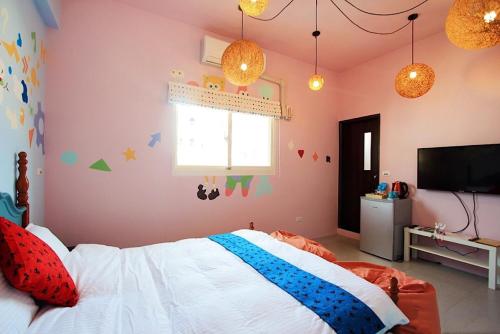 a bedroom with a bed and a tv in it at Happy Forest in Ruisui