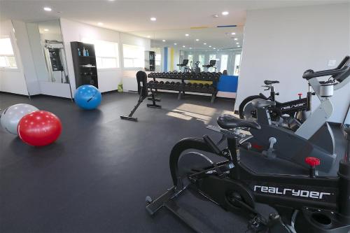 a gym with treadmills and exercise bikes in a room at Clarion Pointe in Medicine Hat