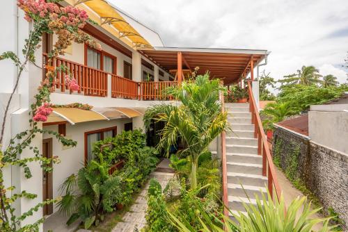 a staircase leading up to a house with plants at Ithaa Dhigurah Maldives in Dhigurah