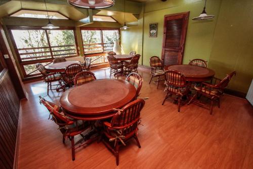 a dining room with wooden tables and chairs at Pousada do Serrano - Em frente a Rua Torta in Gramado