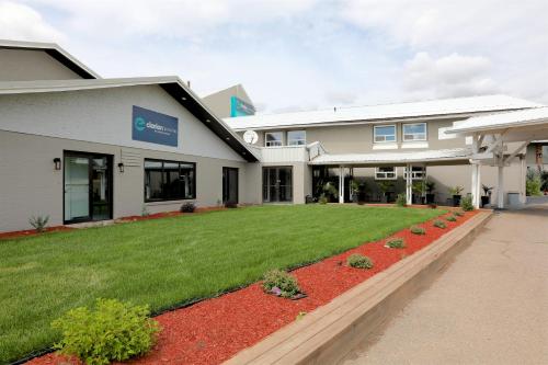 a building with a lawn in front of it at Clarion Pointe in Medicine Hat