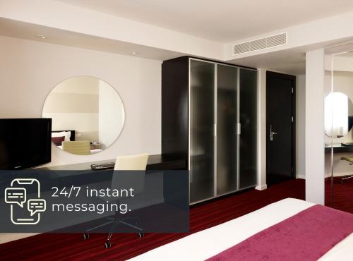 a bedroom with a bed and a mirror at Park Plaza Leeds in Leeds