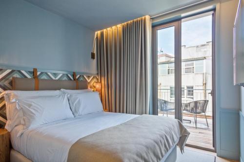 Ένα ή περισσότερα κρεβάτια σε δωμάτιο στο Pur Oporto Boutique Hotel by actahotels