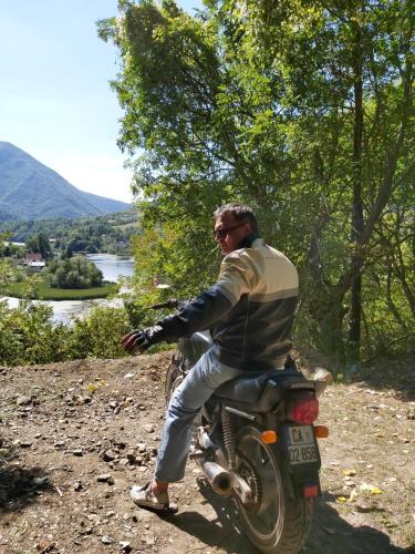 a man riding a motorcycle on a dirt road at Vila Eva in Međuvršje