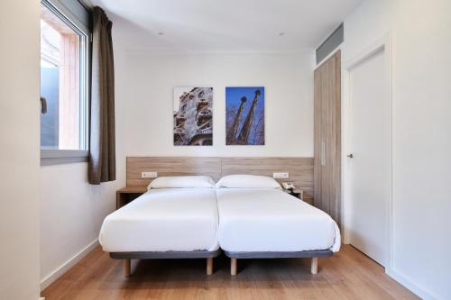 Кровать или кровати в номере Aparthotel Augusta