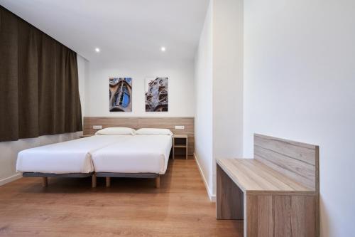 Кровать или кровати в номере Aparthotel Augusta