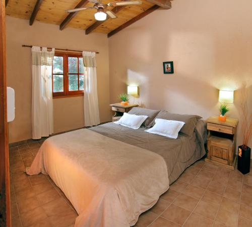 a bedroom with a large bed with two pillows at Complejo el Paine in Villa General Belgrano