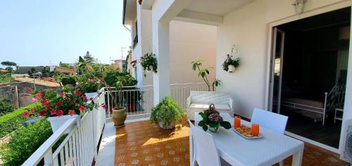a balcony with a table and chairs and plants at La Casa di Andreina in Mondello