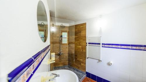a bathroom with a tub and a sink and a shower at Casa El Paraiso Escondido Montecorto by Ruralidays in Montecorto