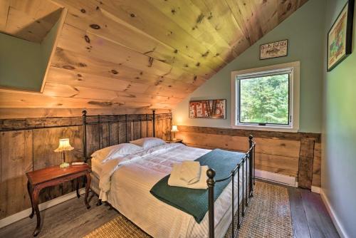 a bedroom with a bed with a wooden ceiling at Historic Catskills Home, Near Willowemoc Creek! in Livingston Manor