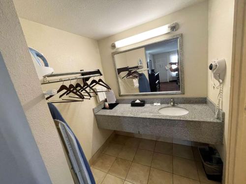 a bathroom with a sink and a mirror at Motel 6 Oklahoma City OK Fairgrounds West in Oklahoma City