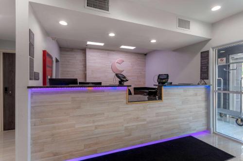 a lobby with a bar with purple lights at Comfort Inn & Suites Memphis East in Memphis