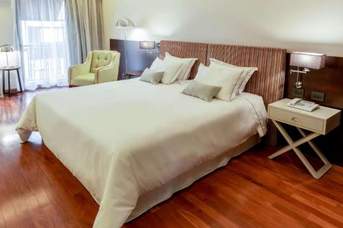 a large white bed in a hotel room at Esplendor by Wyndham Buenos Aires Tango in Buenos Aires