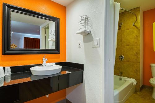a bathroom with a sink and a mirror at Motel 6 Lost Hills / Buttonwillow Racetrack in Lost Hills