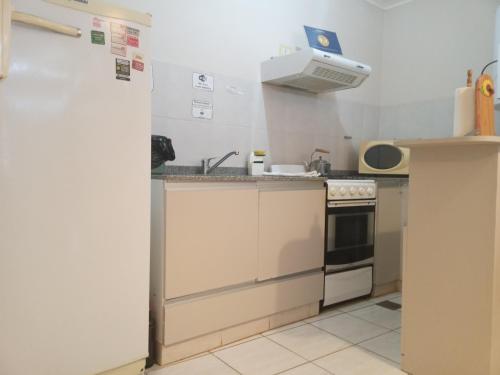 a kitchen with a sink and a stove at Centro Apart "Nuez de la Isla I" in Paraná