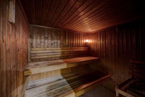 a wooden sauna with a wooden bench in it at Howard Johnson Plaza by Wyndham Dubai Deira in Dubai