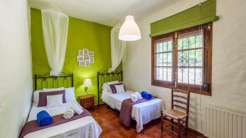 Postel nebo postele na pokoji v ubytování Casa El Rancho Montecorto by Ruralidays