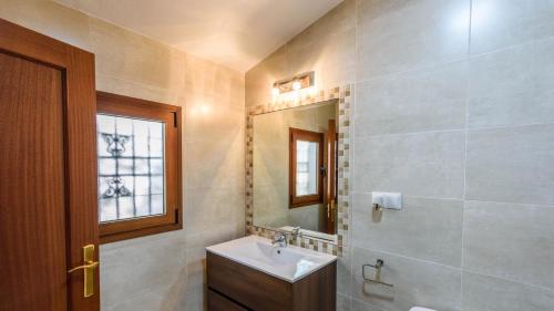 a bathroom with a sink and a mirror at Cortijo Metomela Torrox by Ruralidays in Frigiliana
