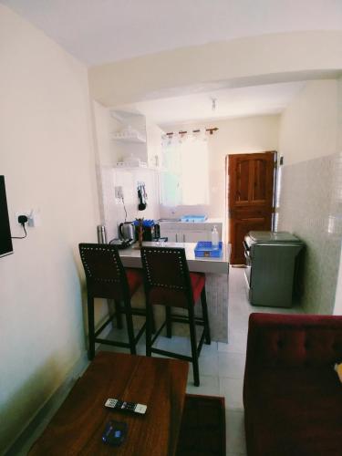 a kitchen with a table and chairs in a room at Ocean View Nyali Boutique Hotel in Nyali