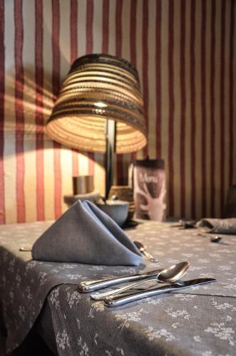a table with a lamp and utensils on it at Hotel Ehrwalderhof in Ehrwald