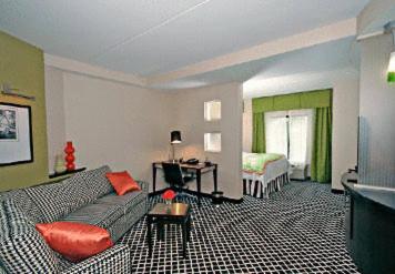 a living room with a couch and a bed at Fairfield Inn Suites Elkin Jonesville in Elkin