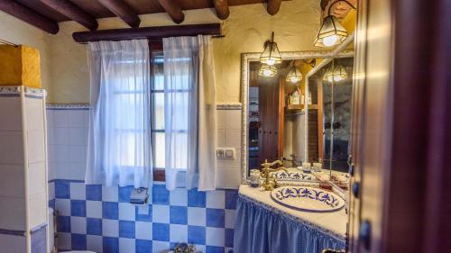 a bathroom with a sink and a mirror at Casa Jara de El Gastor by Ruralidays in El Gastor