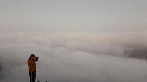 a man taking a picture of the sky with a kite at Ein lahda camp-site in Dana
