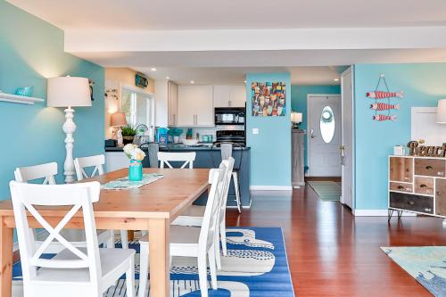 a kitchen and dining room with a wooden table and chairs at Spyglass Beach House in Freeland