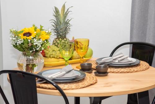 una mesa de comedor con una pieza central de frutas y flores en Luxury Premium Suite in Chalkida, en Chalkida