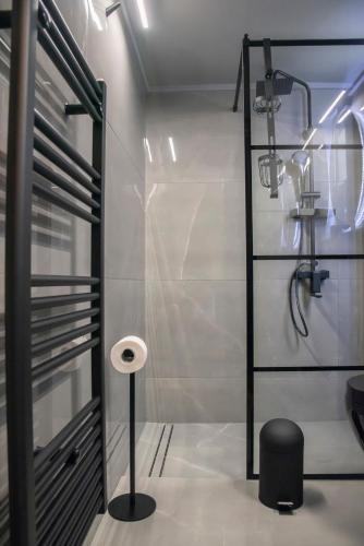 a bathroom with a shower with a toilet and a stool at Luxury Premium Suite in Chalkida in Chalkida