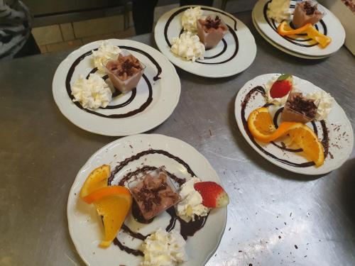 a group of plates of desserts on a table at Zum Obstler - Gaststätte und Pension in Gera