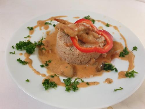 a plate of food with shrimp in a sauce at Zum Obstler - Gaststätte und Pension in Gera