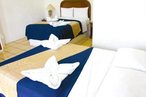 Postel nebo postele na pokoji v ubytování Hotel Ameyali Tequesquitengo