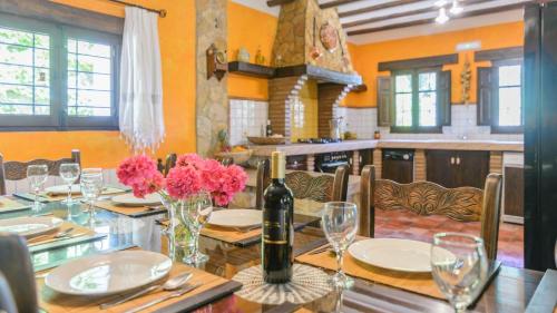 a dining room with a table with a bottle of wine at Mirador de Casablanca Priego de Cordoba by Ruralidays in Priego de Córdoba