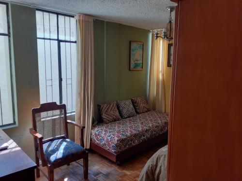 a living room with a couch and a chair at Casa de Tulia in Quito
