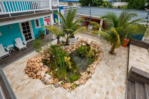 an aerial view of a garden with palm trees at Bed & Bike Curacao - Jan Thiel in Willemstad