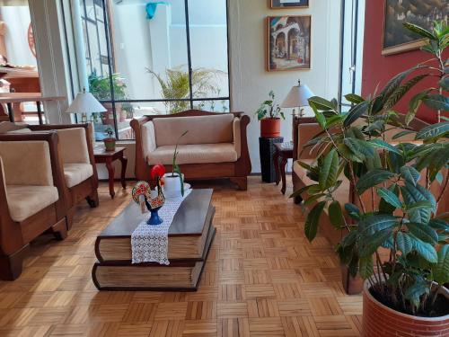 a living room with a couch and a table at Casa de Tulia in Quito