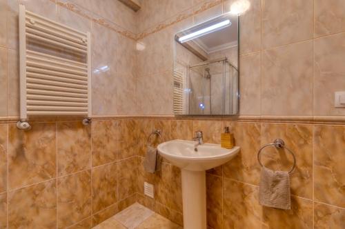a bathroom with a sink and a mirror at Holiday home in Ribamar - Lissabon Region 42000 in Ribamar